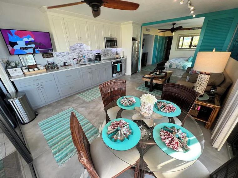 Open living area, kitchen and dining table set for four — a Caribbean vacation without a passport