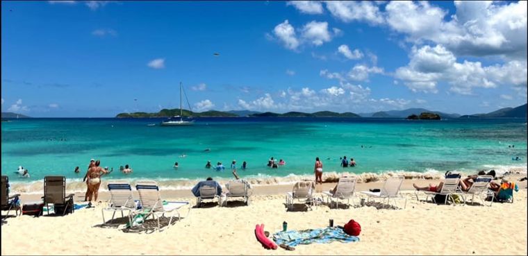 Half-mile white-sand Sapphire Beach with lounge chairs and turquoise water at this St. Thomas beachfront vacation rental