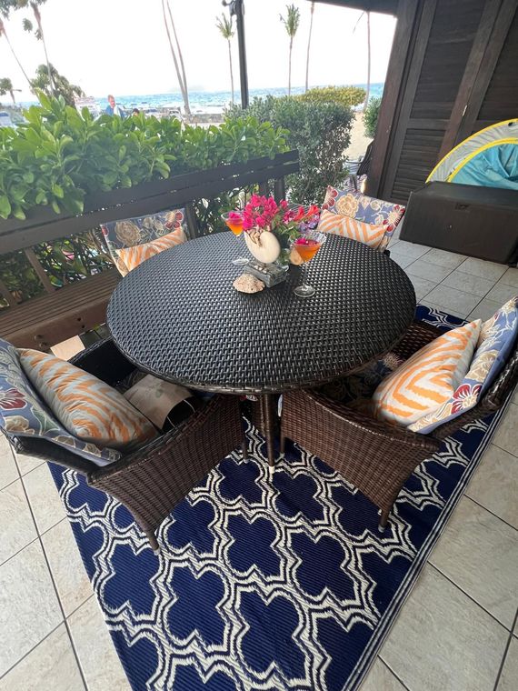 Patio table with fresh flowers under the palms at this St. Thomas condo within walking distance of restaurants